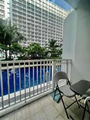 a balcony with a view of the ocean at Sweet Stays 888 in Manila
