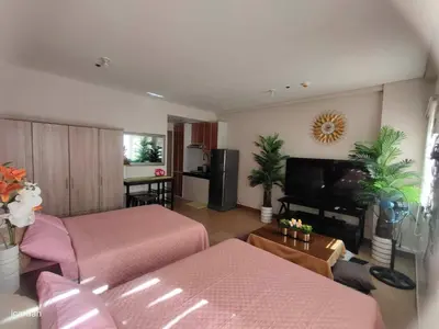 a living room with a couch and a tv at Staycation ni Inday in Trece Martires