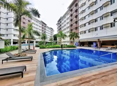 a swimming pool in front of a building at Staycation ni Inday in Trece Martires