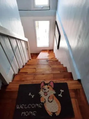 a hallway with a welcome home rug on the floor at Omotenashi House of Santa Rosa City Laguna in Caingin