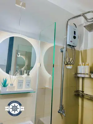 a shower with a glass door in a bathroom at Ocean theme Navy Blue Deluxe Suite with PS4 and Balcony overlooking Manila Bay and Manila Zoo plus near Manila Yacht Club and Star City in Manila