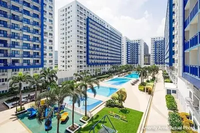 an aerial view of a pool in a city with tall buildings at Sea Residences Homey Condo by DNJ in Manila