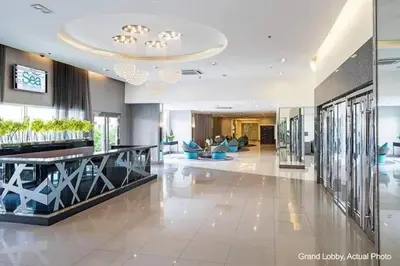 a lobby of a building with a large room with a lobby at Sea Residences Homey Condo by DNJ in Manila