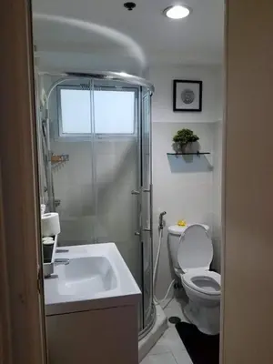 a bathroom with a shower and a toilet and a sink at Sea Residences Homey Condo by DNJ in Manila