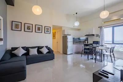 a large living room with a couch and a table at Raya P09 - Airport-Side Penthouse in Manila