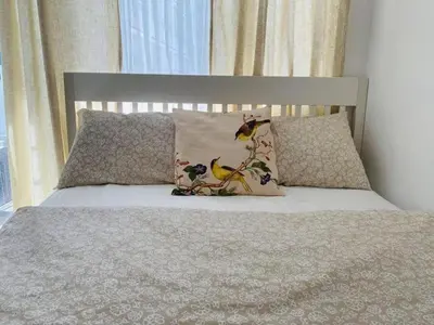a bed with two pillows with a bird on it at Dtravellers Home 2 at SHORE 1 TOWER C (Near MOA) in Manila