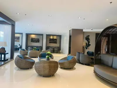 a lobby with couches and tables and chairs at Dtravellers Home 2 at SHORE 1 TOWER C (Near MOA) in Manila