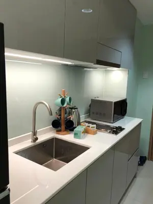 a kitchen with a sink and a microwave at MOA Pasay, Shore 3 Residences - Modern Luxury Condo in Manila