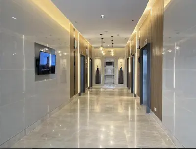 a hallway of a building with a television on a wall at MOA Pasay, Shore 3 Residences - Modern Luxury Condo in Manila