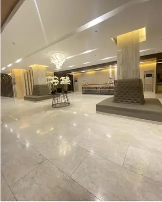 a large lobby with a marble floor and columns at MOA Pasay, Shore 3 Residences - Modern Luxury Condo in Manila