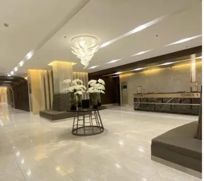 a lobby with a table with flowers on it at MOA Pasay, Shore 3 Residences - Modern Luxury Condo in Manila