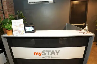 a sign that says my staylords on a reception desk at mySTAY Hotel BGC West in Manila