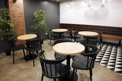 a row of tables and chairs in a restaurant at mySTAY Hotel BGC West in Manila