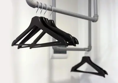 a couple of black hangers hanging from a pole at mySTAY Hotel BGC North in Manila