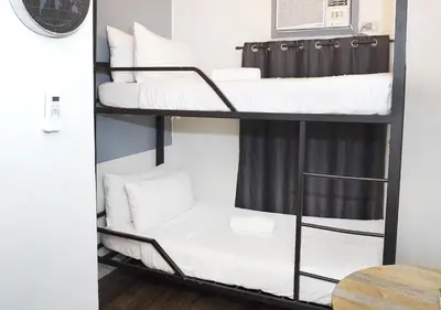 a room with three bunk beds on a shelf at mySTAY Hotel BGC North in Manila