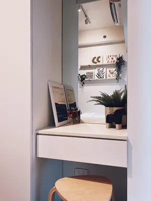 a desk with a wooden stool in a room at Makati Cosy Home l Couples Families l 500Mbps Wifi in Manila