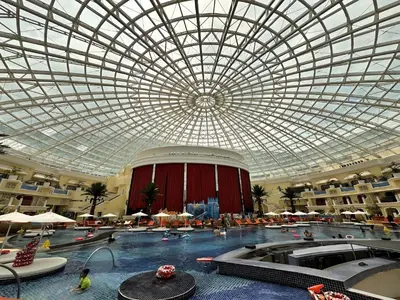a large indoor swimming pool with a domed ceiling at 1BRFacing ManilaBay SunsetNear Okada Solaire 1Park in Manila