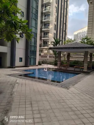 a swimming pool with a gazebo and buildings at Rqui CondoTel Near Airport in Manila
