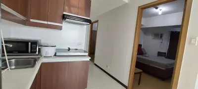 a kitchen with a sink and a bed in a room at SnugglePod Condotel - Grand Riviera Suites, US Embassy Manila, Roxas Blvd in Manila