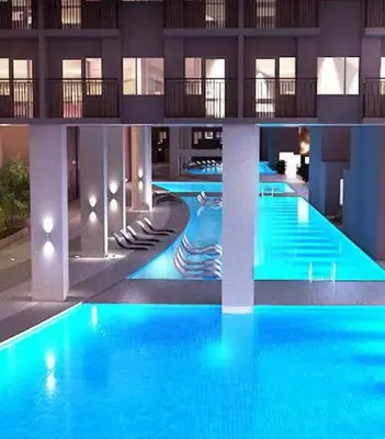 a large pool with blue water in a building at LIGHT HOUSE ( MOA STAYCATION) in Manila