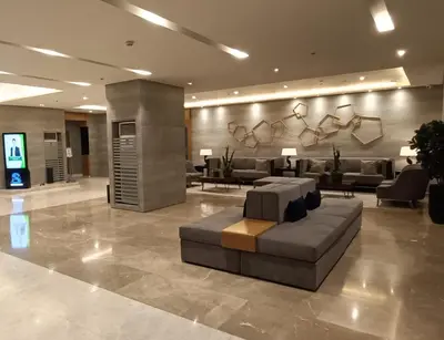 a lobby with a couch and couches in a building at LIGHT HOUSE ( MOA STAYCATION) in Manila