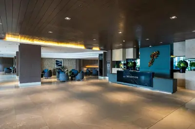 a lobby of a hotel with chairs and a television at Luxury Seaside Sunset View at SM Mall of Asia with free parking in Manila