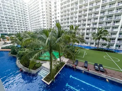an aerial view of a large apartment building with a tennis court at Luxury Seaside Sunset View at SM Mall of Asia with free parking in Manila