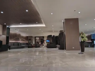 a lobby of a hotel with couches and tables at Luxury Seaside Sunset View at SM Mall of Asia with free parking in Manila