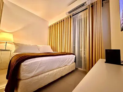a hotel room with a bed and a window at Luxury Seaside Sunset View at SM Mall of Asia with free parking in Manila