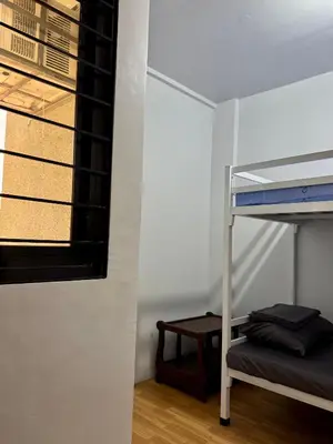 a room with a bunk bed and a window at Sebastians Crib in Dasmariñas