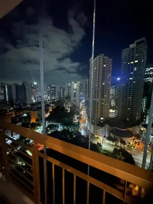 a view of a city skyline at night at Cozy Place with City View at Greenbelt Makati in Manila