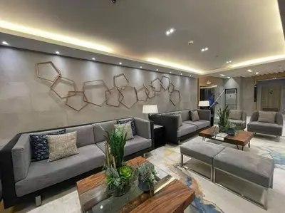 a large living room with couches and a wall at S ResidencesTower 3 - L&R Staycation in Manila