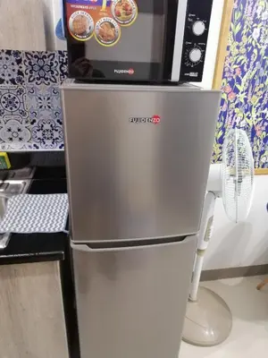 a microwave oven sitting on top of a refrigerator at S ResidencesTower 3 - L&R Staycation in Manila