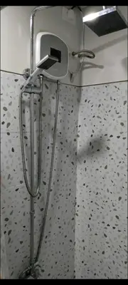 a bathroom with a towel dispenser on a wall at S ResidencesTower 3 - L&R Staycation in Manila
