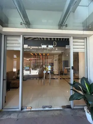 a large glass door of a building with a lobby at One Palm Tree Villas short walk via Runway Manila NAIA T3 in Manila