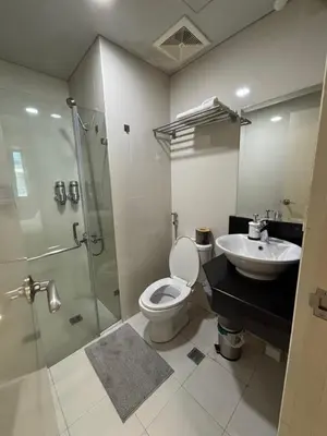a bathroom with a shower and a toilet and a sink at One Palm Tree Villas short walk via Runway Manila NAIA T3 in Manila