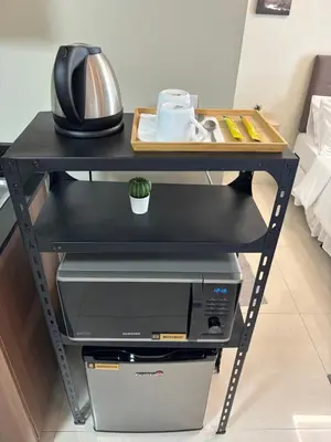 a desk with a printer and a computer on it at One Palm Tree Villas short walk via Runway Manila NAIA T3 in Manila