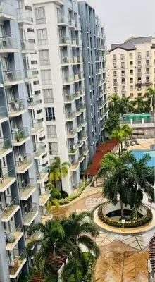 an aerial view of apartment buildings and a courtyard with palm trees at One Palm Tree Villas short walk via Runway Manila NAIA T3 in Manila