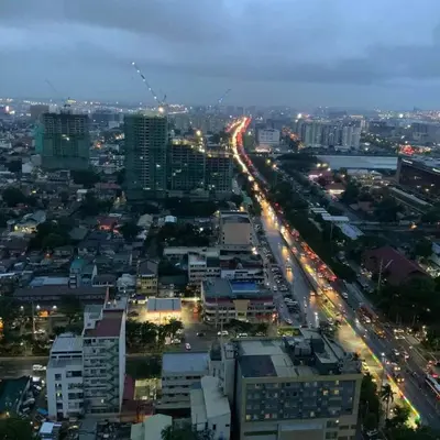a city at night with traffic on a highway at City and Sea view Staycation at Coast Residences in Manila
