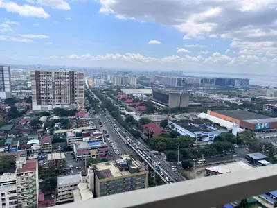 a view of a city with buildings and traffic at City and Sea view Staycation at Coast Residences in Manila