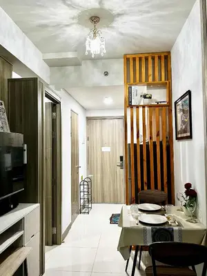 a living room with a table and a dining room at City and Sea view Staycation at Coast Residences in Manila