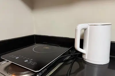 a white mug sitting on top of a stove at Del's Condotel across NAIA Terminal 3 in Manila