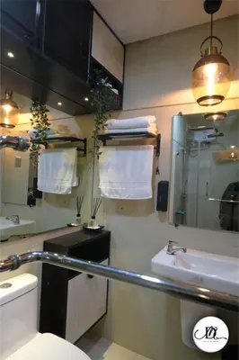 a bathroom with a toilet and a sink and a mirror at DM's Place Family Suite B - Condo in Pasay in Manila