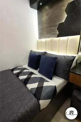 a bed with blue pillows on it in a room at DM's Place Family Suite B - Condo in Pasay in Manila