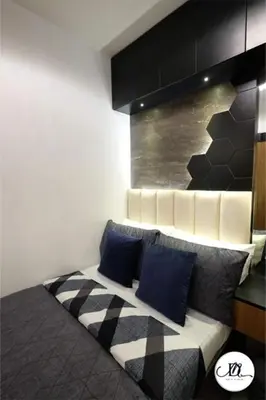 a couch with two blue pillows in a room at DM's Place Family Suite B - Condo in Pasay in Manila