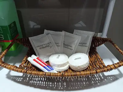 a basket filled with toothbrushes and toothpaste at Marivic's Place at Air Residences Makati in Manila