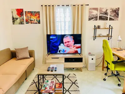 a living room with a flat screen tv in it at Awesome 2 bedrooms, living & dining area in General Trias