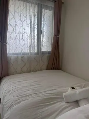 a bed in a room with a window at Staycation Mandaluyong Fame residences greenfield district by darpm in Manila