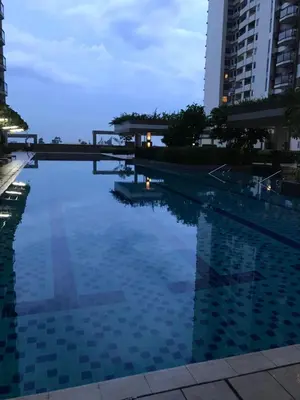 a swimming pool in a city at night at Best Value Q Condo Radiance29S near Airport, Casinos, Star City, MOA, PICC, Harbour Square, Dolomite Beach in Manila