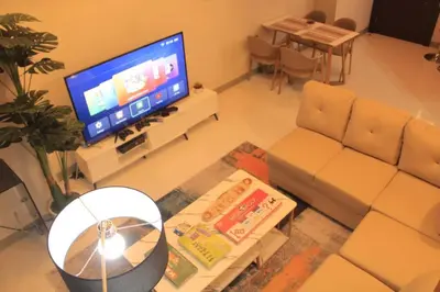 a living room with a couch and a television at A2J Luxury 3BR Suite Near Uptown Mall BGC Taguig in Manila